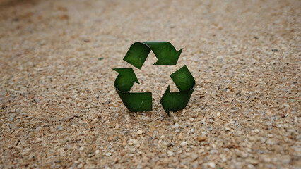 Green recycling symbol on a sandy beach background, illustrating the concept of environmental conservation, sustainability, and protecting our planet