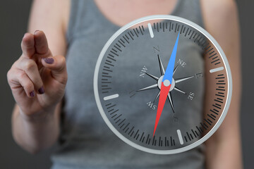 Fototapeta premium A person uses a compass to guide and point the direction, symbolizing strategy, navigation, and exploration.