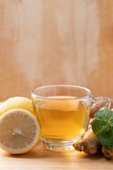 Lemon and ginger tea in cup glass with mint leaf, Healthy hot drink