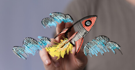 Abstract illustration of a hand holding a drawing of a rocketship. The concept includes launch,...