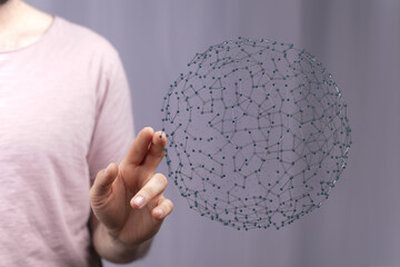 Close-up of a man's hand interacting with a 3D digital sphere, symbolizing connectivity, technology, and global networks. Illustrating data, com