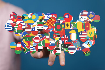 A hand holding a collection of diverse world flags, symbolizing international cooperation,...