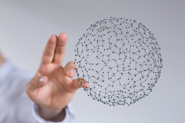 Close up of a hand reaching for a digital sphere, representing networks, connections, and technology. Ideal for illustrating digital concepts, d
