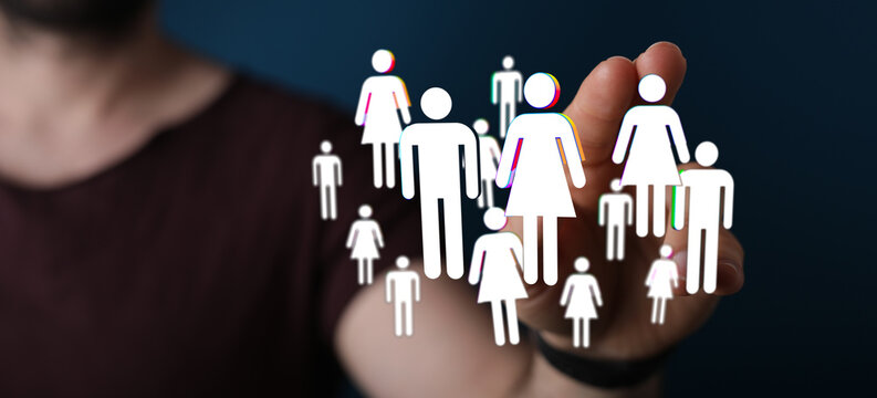 Hand reaching towards a group of people icons, representing social connection, communication and community. Concept for business, teamwork, and