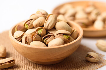 Roasted pistachios with salt, healthy snack on white background