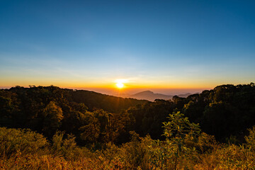 The beautiful sunrise at Doi intanon national park, Chiang Mai in the morning.Sun is rising from the hill to shy with beautiful yellow orange light.