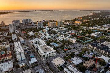 Above view of Sarasota city, Florida with waterfront office high-rise buildings. Development of...