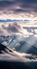 Dramatic mountain vista with cloud inversions and ethereal sun rays light