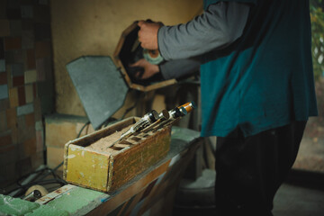Latino man working in his workshop. Knife maker.