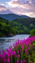 A river flows through forested mountains; wildflowers bloom in the foreground