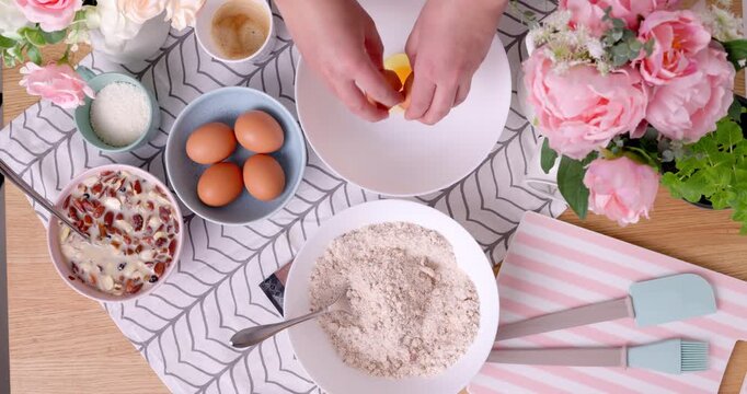 Cooking scene woman baker whisking eggs In white bowl for baking healthy breakfast and preparing wholemeal gluten free homemade cake sweet dessert