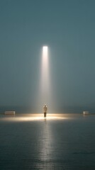 Fototapeta premium Solitary Figure Bathed in a Beam of Light on a Wet Reflective Surface Under a Moody Sky