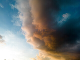 An aerial hyper lapse of colorful clouds at blue hour. Saturated colors and sun rays filtering through the cloud cover add to the beauty of the photo.