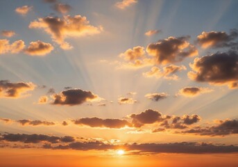 A peaceful evening sky with scattered cumulus clouds glowing in warm orange, pink, and light blue hues. The sun sets below the horizon, casting soft light rays upward. Captured in full HD from a groun
