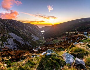 A breathtaking landscape photo captures a valley between mountains bathed in the warm light of sunrise. Clouds and textures add depth