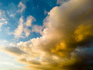An aerial hyper lapse of colorful clouds at blue hour. Saturated colors and sun rays filtering through the cloud cover add to the beauty of the photo.