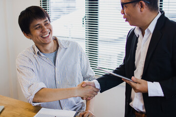 Colleagues Greeting New Team Member with Handshake in Modern Office