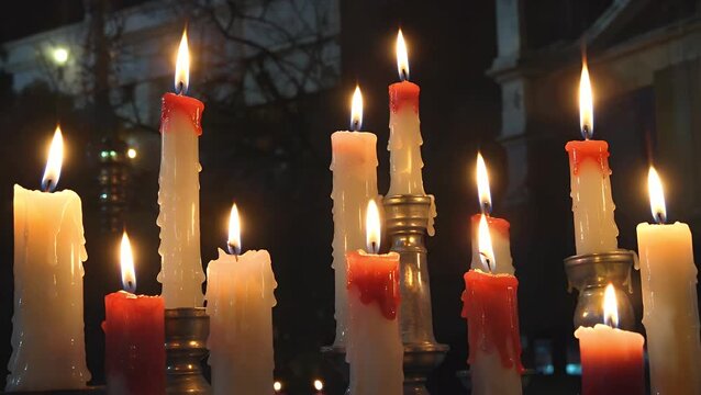 Wax Tapers Burning in a Low-Light Environment  The Glow from Candle Flames Used as a Decorative Element After