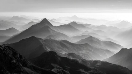 Obraz premium Dramatic monochrome mountain range landscape with layered peaks and mist
