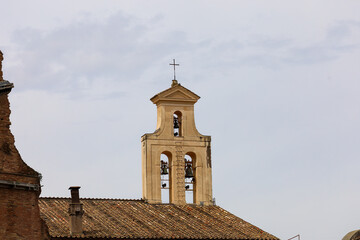 The Bells of Santi Cosma e Damiano, Rome, Italy. Church bell tower on top of roof.