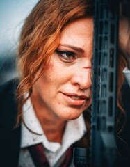 Redhead woman in a suit with a rifle. Special agent.
