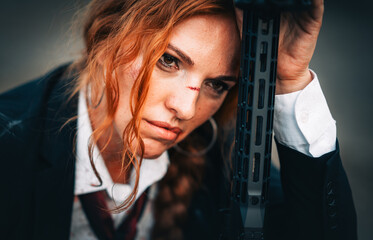 Redhead woman in a suit with a rifle. Special agent.
