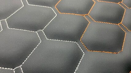 Beautiful thread stitching on the black leather. purpose for background