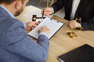 Business people review contract, lawyer and client discuss legal agreement during meeting in law...