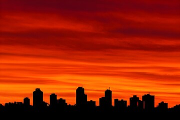 Fototapeta premium City Skyline Silhouette Against Fiery Dawn Sky Urban Landscape Sunrise Morning Light Metropolitan Horizon View