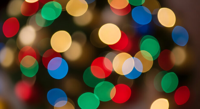 Colorful glowing circles of light in a soft focus bokeh effect, perfect for a festive party or holiday concept