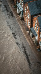 Rising Tide of Disaster: Flooded Residential Area with Water Flowing Between Houses