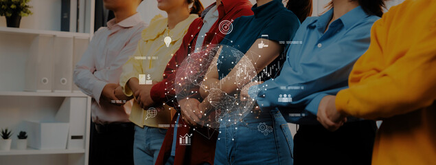 A diverse group of professionals standing together, arms crossed, with a digital interface overlay...