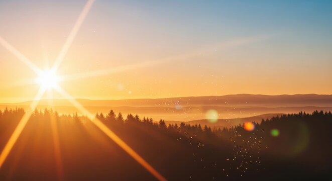 Golden sunrise breaking over a misty forest landscape with lens flare.