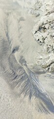 Detailed natural textures of sand sculpted by receding water flow