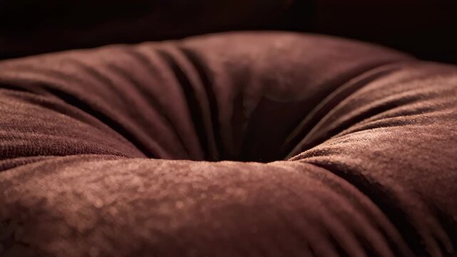 Close Up of Book With Bookmark Sitting on Maroon Velvet Cushion