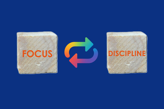 “FOCUS vs DISCIPLINE” wooden blocks with looping arrows—ideal for visuals on mindset, productivity, goal setting, and personal growth.	