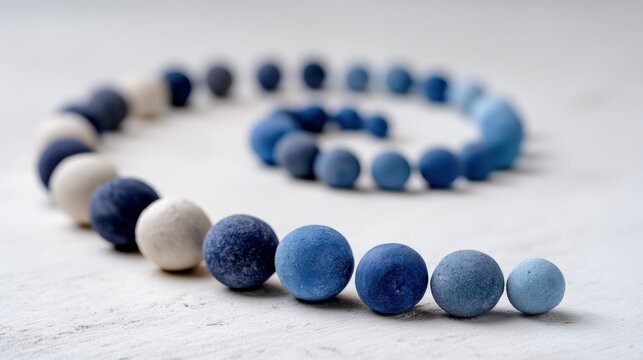 A blue and white bead necklace with a blue and white background.