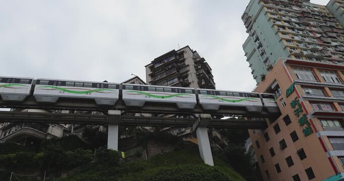 Many visitors taking photo with smart phone at the rail transit Liziba station in Chongqing city, China