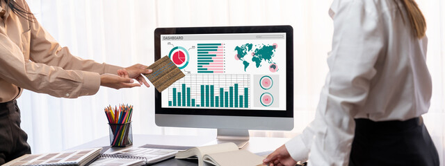 Group of interior architect designer team at table choosing various mood board samples with...