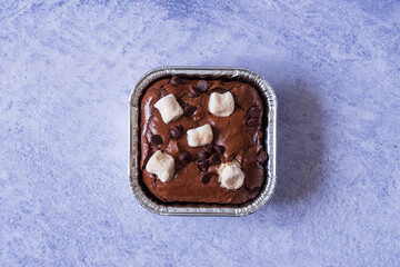 Homemade fudgy chocolate brownies on grey background. chocolate walnut brownie cake still life
