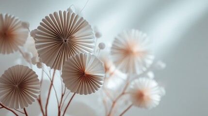 Obraz premium A close-up of a white and gold paper flower arrangement with a blurred background.
