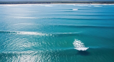 Aerial view of breaking ocean waves with a boat wake creating foam