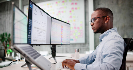 Young African American Man Using Laptop