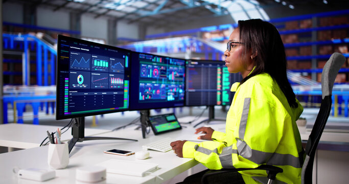 Warehouse Manager Overseeing Logistic Operations On Desktop Pc