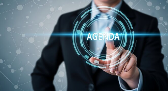 A businessperson touching a digital screen displaying the word agenda surrounded by a futuristic interface in a corporate setting