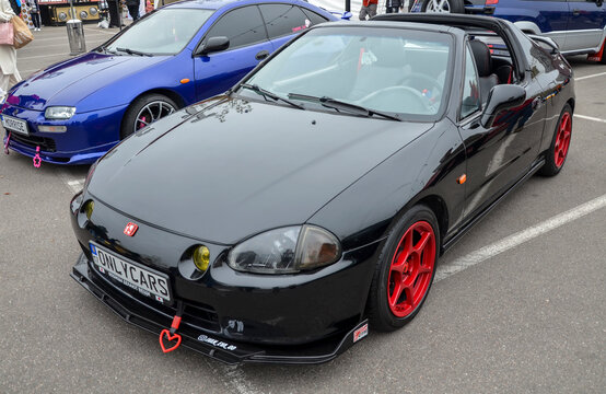 Dynamic black Honda CRX Del Sol, a two-seater targa-top roadster  highlighting the open air driving experience