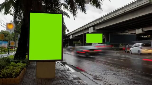 Rainy City Street with Vertical Green Screen Billboard and Reflections
