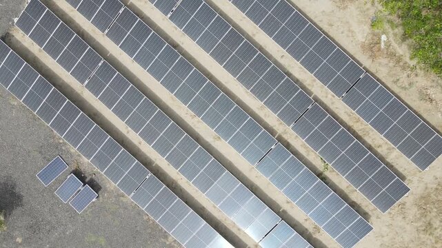 A stunning aerial view of a solar power plant showcases rows of photovoltaic panels converting sunlight into clean electricity, symbolizing innovative sustainable and renewable energy.