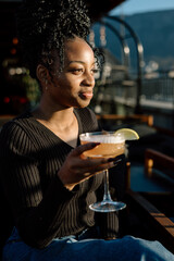 Women drinking a cocktail in an outdoor bar
