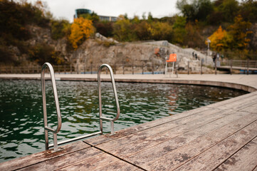 Outdoor Pool with Wooden Deck and Ladder